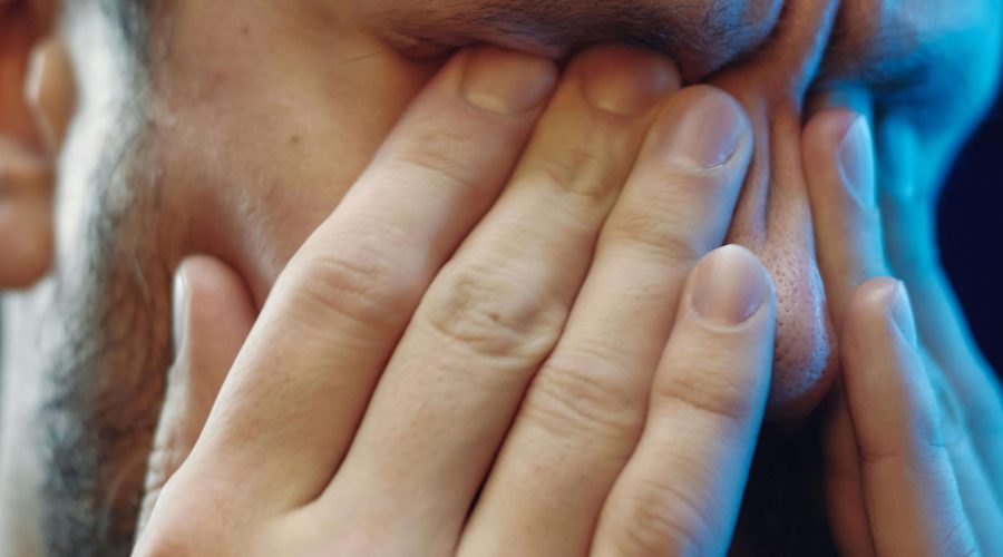 Tired person rubbing eyes in the morning – Common reasons you wake up sore and how to fix it